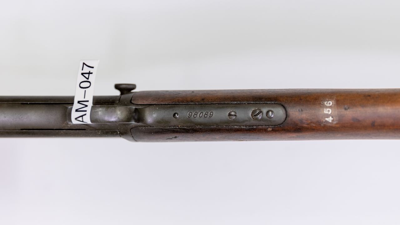 Identification markings on a pump-action rifle.