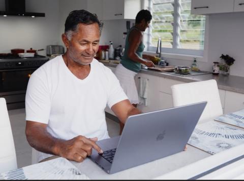Person on laptop in home environment